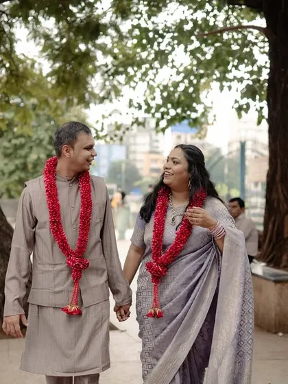 The couple walks down a tree-lined city path, engrossed in their own world. This shot shows how even a simple walk can become a beautiful photo opportunity when the connection is real.