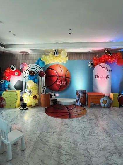 A slam dunk of a party setup. This basketball-centric theme features a massive 3D basketball, themed backdrops, and balloon arches in team colors.