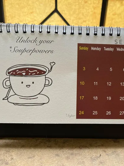 The September page from my 2023 calendar, with a bowl of soup to help you "Unlock your Souperpowers".