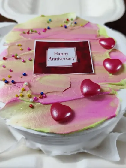 For a more intimate celebration, I offer these personal-sized bento cakes. This one was for an anniversary, decorated with a simple, modern frosting design, heart-shaped candies, and a custom message topper.