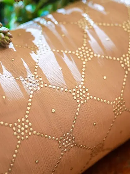 A detail shot of a hand-painted bolster cushion, adding another layer of custom artistry to the seating arrangement.