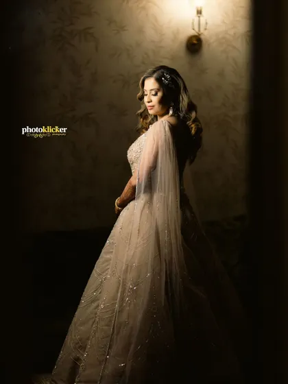 A full-length portrait of the bride-to-be in her stunning engagement gown, captured with dramatic lighting to create a moody and sophisticated look.