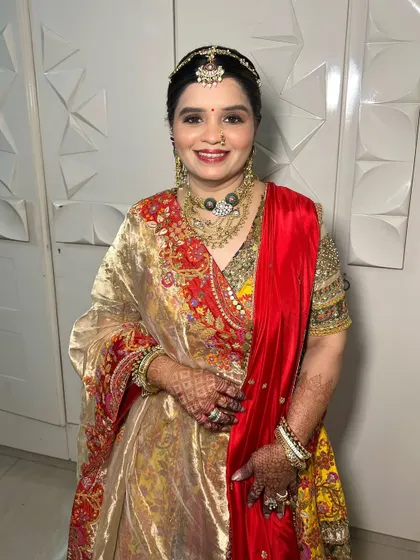 A full-length view of the mother of the bride's stunning traditional outfit, perfectly complemented by her glamorous makeup.