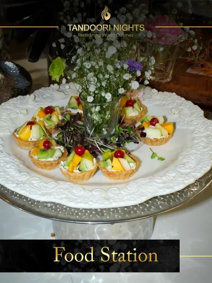 Our multi-cuisine food stations add charm to any event. This station features beautiful fruit tartlets, ready to delight guests as the sun goes down.