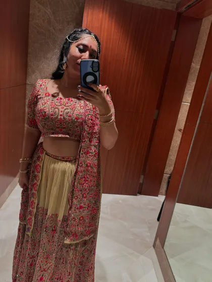 A mirror selfie showing off my full lehenga for a sangeet event. I believe dressing for the theme adds to the overall experience.