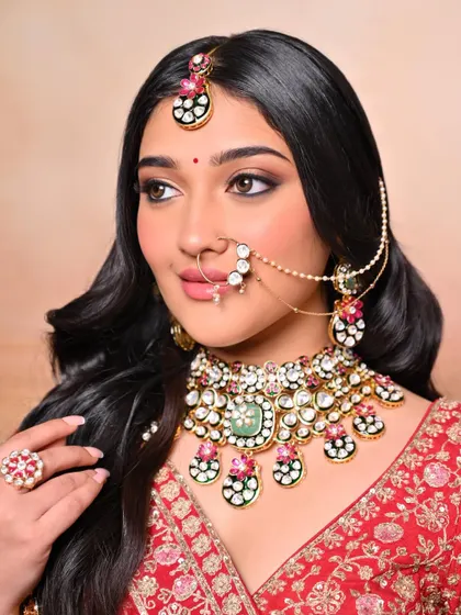Another angle of the royal bridal look, highlighting the intricate jewelry and the perfectly defined features.