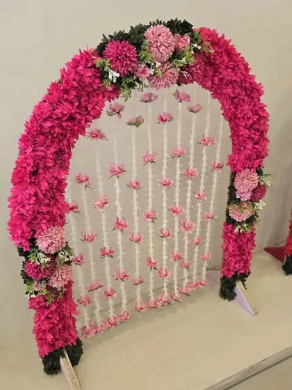 A sweet and simple all-pink floral arch, this piece is perfect for adding a touch of charm to your home celebration.