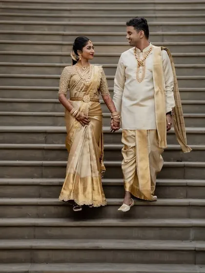 A classic portrait at a destination wedding, with the couple in elegant gold attire reflecting the grandeur of the venue. We excel at blending tradition with magnificent settings.