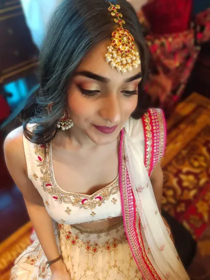 Another angle of this beautiful festive makeup, showing the soft contouring and the way the hairstyle frames the face and accommodates the traditional hair accessory.