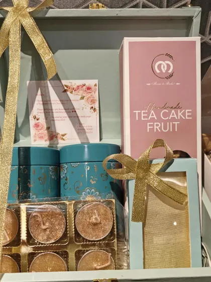 A special edition Diwali trunk hamper. This one is filled with a handmade fruit cake, decorative tins for cookies or tea, and a set of six glittery diyas.
