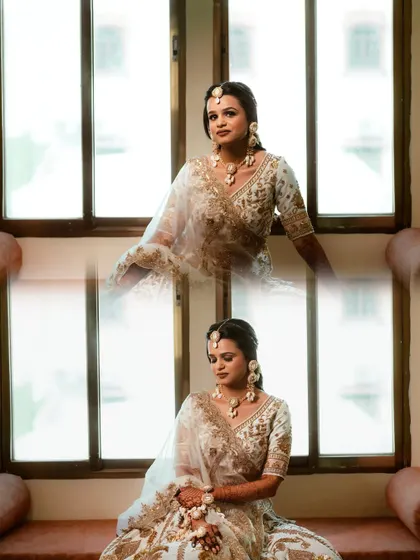 A beautiful portrait of the bride by the window, her white and gold lehenga looking ethereal in the natural light.