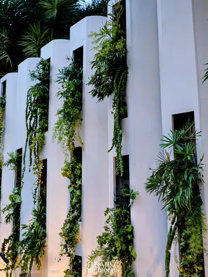 A detail shot of the vertical garden wall we created for the band's stage. The cascading greenery adds a lush, organic element that enhances the overall garden party theme.