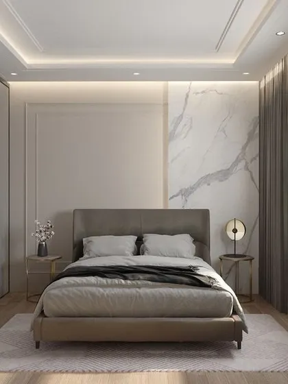 This guest bedroom is designed with comfort and elegance in mind. A marble accent wall provides a touch of luxury, while the floor-to-ceiling wardrobes offer ample storage. The neutral color palette and soft lighting create a welcoming retreat for visitors.