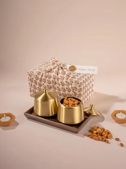 Another angle of Doro's brass gift containers, this time showing one open with dry fruits. This shot highlights the product's use as a premium container for festive treats.