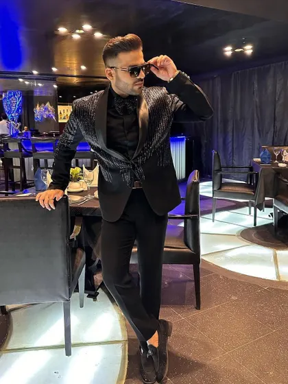 Our client strikes a pose in his striped sequin tuxedo, looking confident and ready for a night out.