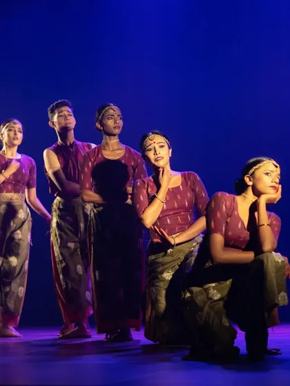 A poignant group scene from 'Rasadrishta', where dancers express a range of emotions through their synchronized movements and expressions.