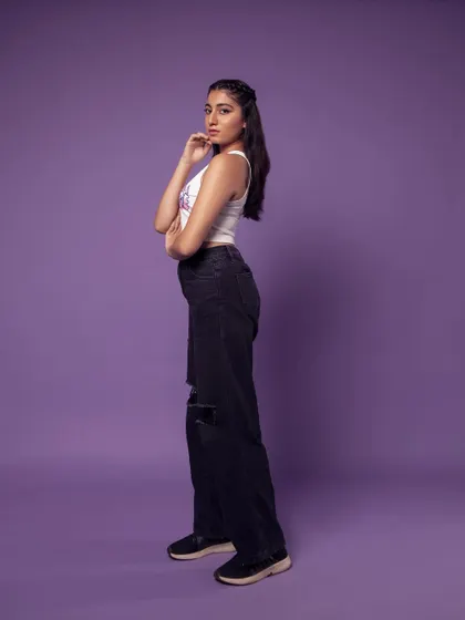 A full-length side profile. This is a great way to show the fit of the ripped jeans.