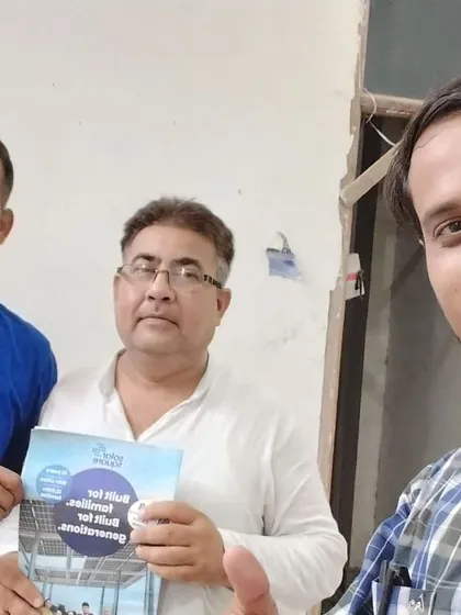 Our team takes a selfie with a customer holding our "Built for Generations" booklet.