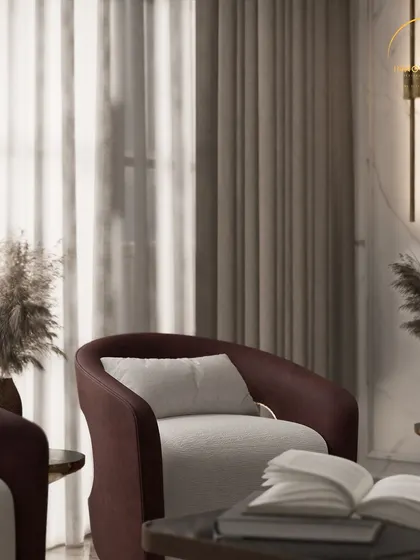 A close-up shot of an accent chair in a luxurious living room. The focus is on the rich textures of the fabric, the elegant brass details, and the pampas grass decor, all coming together to create a corner of pure sophistication.