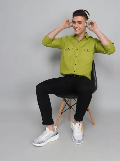 A lifestyle model shot showing a man enjoying music while wearing the product. This helps create a narrative and connects the clothing to a specific lifestyle or activity.