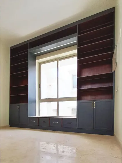 Another view of the library unit during construction, highlighting the clean lines and the perfect fit of the floor-to-ceiling design.