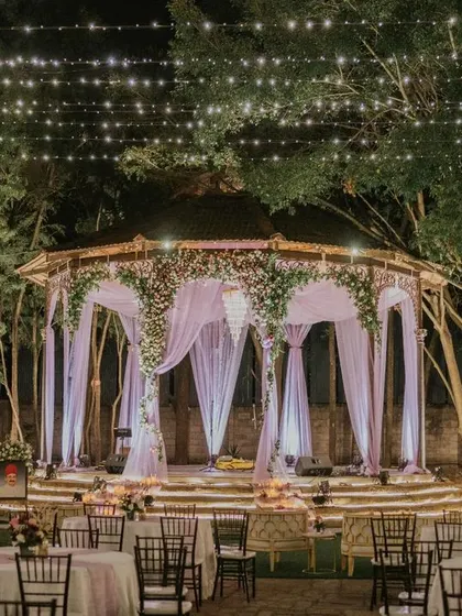 The ambiance before guests arrive holds a quiet magic. This shot of Ridhi and Prashanth's cocktail party setup at The Tamarind Tree shows the elegant stage and seating we prepared for an unforgettable night.