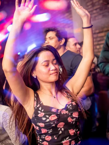 A guest with her hands in the air, completely lost in the music at Roxy. This is the vibe I strive for.