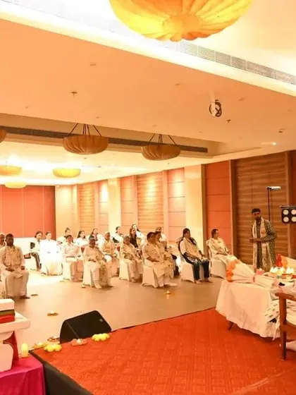 A view from the back of a Satsang session, showing us guiding the participants.
