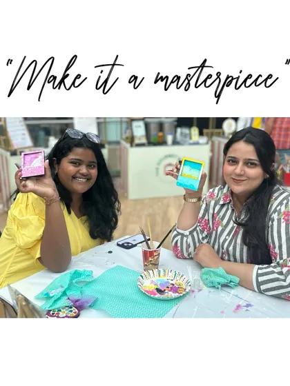 "Make it a masterpiece." Two friends showing off the mini canvas art they made at our stall.