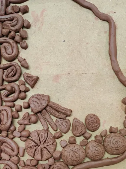 This abstract clay silhouette is filled with a variety of shapes and textures. It's a fantastic exploration of form and composition.