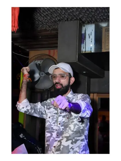 A high-energy pose, pointing at the crowd. I make sure to engage with everyone and make them feel like part of the show.