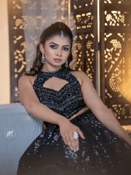 A full view of the stunning black lehenga and the confident pose.