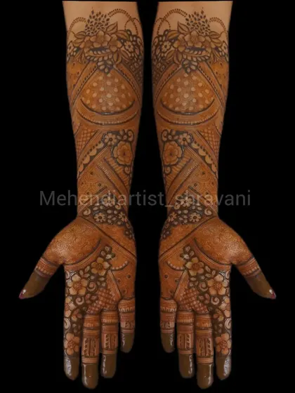 A classic and symmetrical design suitable for a bridesmaid or guest. It features floral and paisley patterns that cover the hands and extend partially up the arm.