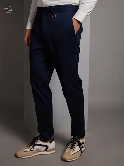 The foundation of a great outfit often starts with the right trousers. This image details the side-adjuster on a pair of my bespoke navy trousers, a feature that ensures a perfect fit without a belt.