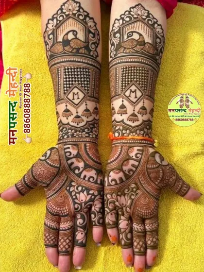 A classic bridal design featuring peacocks, elephants, and hanging jhumkis. The personalized initial 'M' adds a modern touch to the traditional motifs.