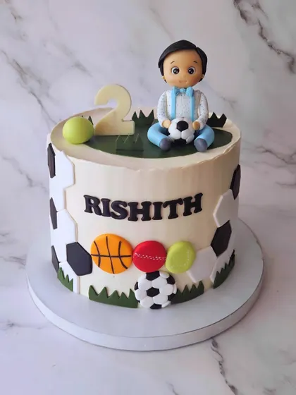 For a little boy who is crazy about balls. This vanilla and caramel cake for Rishith's 2nd birthday is decorated with footballs, basketballs, and tennis balls.