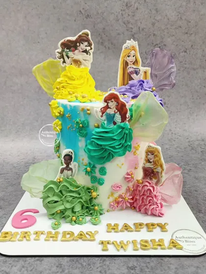A dream cake for a Disney Princess fan. This design showcases five different princesses, each with a beautifully piped buttercream dress, creating a colorful and royal celebration cake.