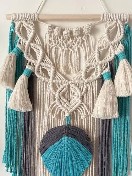 This is a custom-colored tapestry with tassels and a macrame feather. The combination of off-white, grey, and teal is so fresh and modern.