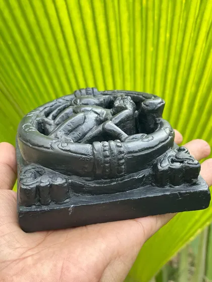 A side view of our monkey and grapes plaque, showing the depth and detail of the carving in Krishna shila stone.
