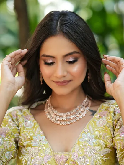 A close-up of the eye makeup. The champagne shimmer on the lids catches the light beautifully, creating a dreamy and romantic effect.