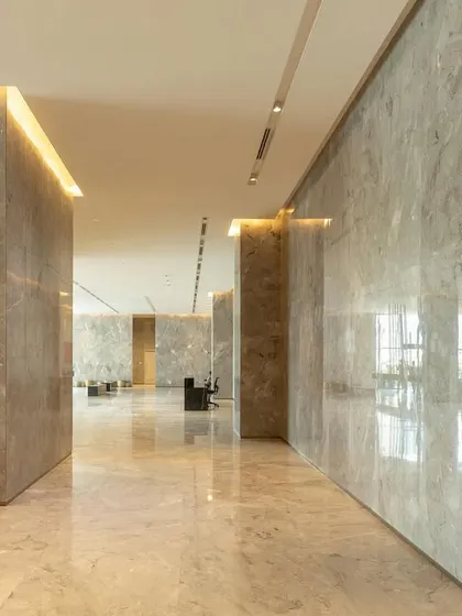The lobby of the One Golden Mile office building is conceived as a calming transition from the chaos of the city. We used large slabs of polished marble and a minimalist design to create a serene, expansive space that puts people at ease.
