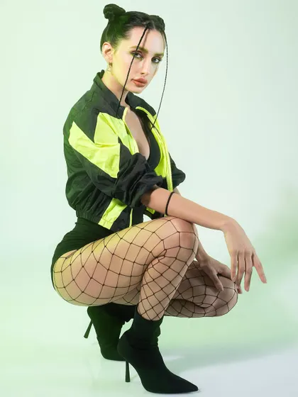 Embracing electric energy with this sporty, high-fashion look. I styled a neon and black windbreaker with fishnet stockings and bold makeup to create a vibrant and edgy aesthetic.