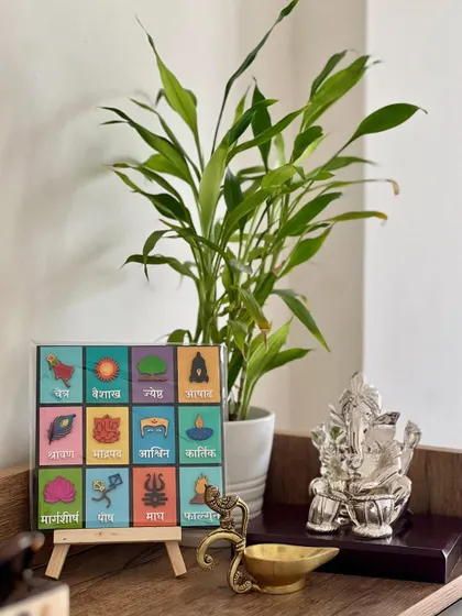 My Marathi months calendar looking beautiful on a client's table, placed next to a Ganesha idol. It can be hung on a wall or placed on an easel.