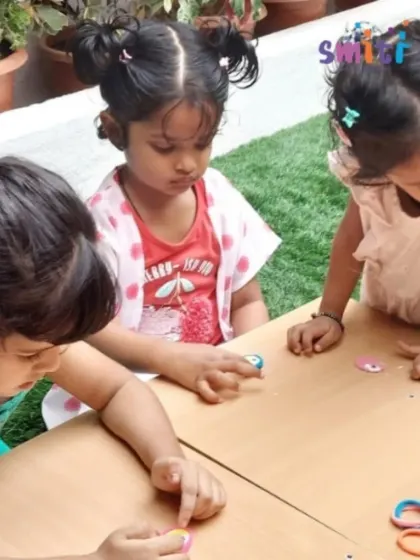 Toddlers explore different materials for Rakhi making. Even our youngest children participate in hands-on creative activities, developing their sensory and motor skills.