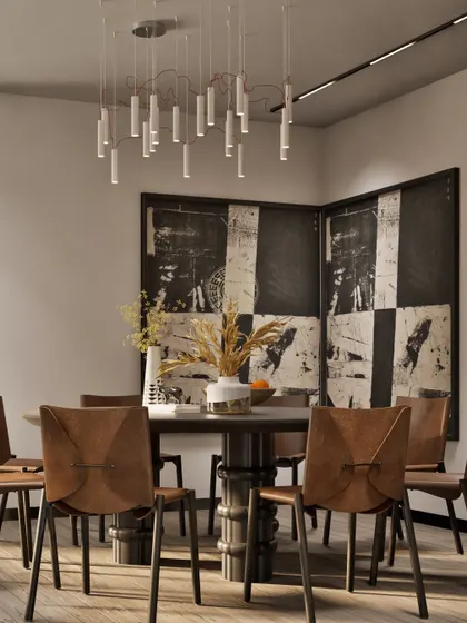 The dining area features leather-backed chairs with a unique design, gathered around a sculptural round table. A modern chandelier and large abstract artwork complete this sophisticated space for entertaining.