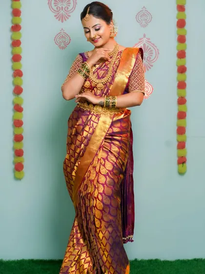 A full-length shot showcasing the elegant drape of the bridal saree. This type of photo is essential for capturing the complete wedding day look.