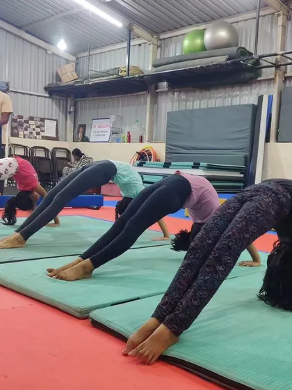 This image is a duplicate of 34, showing a group of students working on their bridge pose. We focus on proper form to ensure they build strength and flexibility safely.