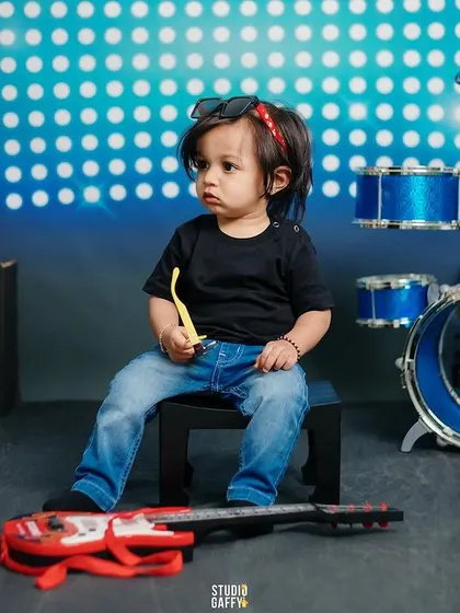 A tiny rockstar takes a break from drumming to think about his next song.