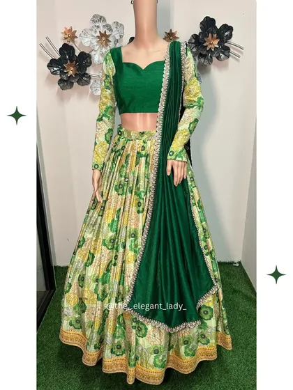 A full-length view of the green floral printed lehenga, showing its unique design and vibrant colors. A perfect choice for a garden party or daytime wedding event.
