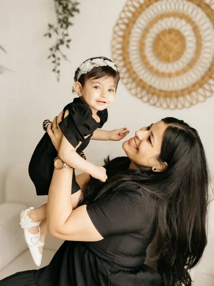 A mother lifting her daughter high. The joy on both their faces is what I aim to capture.